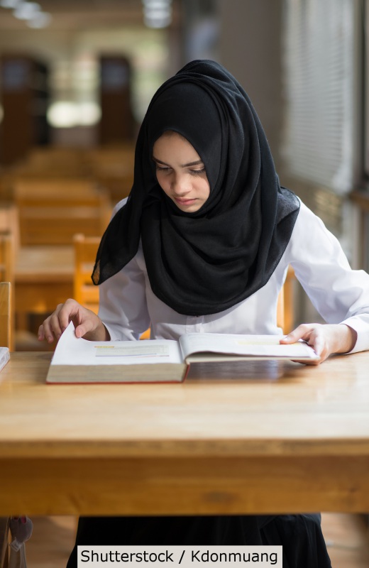 Muslim student studying at library | Shutterstock, Kdonmuang